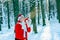 Santa Claus blows snow. Happy Santa blowing on snow. Winter time. Photo of Santa Claus blowing snow over nature