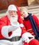 Santa Claus And Boy Taking Selfportrait Through