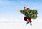 Santa Claus Carrying Christmas Tree on Snow