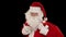 Santa Claus carrying his bag, looks at the camera sends a blow kiss and wave, black, stock footage