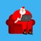 Santa Claus on chair working in laptop. Christmas work. New Year