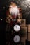 Santa Claus, clock and christmas gifts on a black background