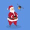 Santa Claus controls drone with christmas gift box