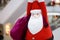 Santa Claus doll. A giant Santa Claus soft plush doll is hanging down from the ceiling with a big bag of present inside