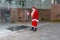 Santa Claus entering a building with a mask on Christmas