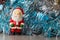 Santa Claus figurine and blue and silvery tinsel
