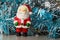 Santa Claus figurine and blue and silvery tinsel