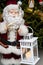 Santa Claus figurine with candle holder at Xmas tree