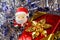 Santa Claus figurine with gifts and blue and silvery tinsel