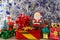 Santa Claus figurine with gifts and blue and silvery tinsel