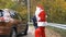 Santa Claus gets into the car with a personal chauffeur 50 fps