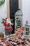 Santa Claus and gingerbread man toys standing on brown plaid with decorative lanterns and Christmas presents.