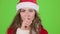 Santa claus girl in red suit points her finger a little more quietly. Green screen. Close up