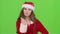 Santa claus girl in red suit points her finger a little more quietly. Green screen. Close up
