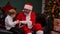 Santa Claus gives a cherished gift to a little boy, the child rejoices and hugs the magic grandfather. Holidays and