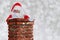 Santa Claus Going Down Chimney making Shh sign with finger to lips