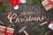 Santa Claus hand carved Merry Christmas text on wooden surface with chisel and hammer