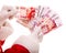 Santa Claus hand with money Russian rouble.