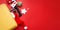 Santa Claus hat lies in yellow suitcase, christmas baubles and gifts on red background. Concept: tourist trips, vacation, travel