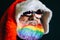 Santa Claus in hat and sunglasses is laughing. Rainbow flag on the beard. LGBT friendly. Celebration concept. 2020 new year