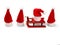 Santa Claus hats, one is sitting on a sled
