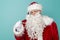 Santa Claus having fever measuring temperature using thermometer