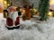 Santa claus hold bell near ornament lighting bulb at silent night, holy night, Merry Christmas and happy new year.
