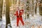 Santa Claus hold Christmas gift and comes in the snow forest.