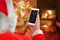 Santa Claus hold white smart phone with blank screen for mockup