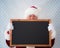 Santa Claus holding blackboard