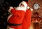 Santa Claus holding carrying sack with gifts
