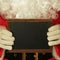 Santa Claus holding chalkboard for text