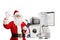 Santa claus holding a clipboard and gesturing a good sign in front of home appliances