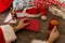 Santa Claus holding an envelope at his wooden table with gifts