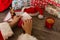 Santa Claus holding an envelope at his wooden table with gifts