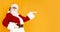 Santa Claus holding hand for your text over orange background