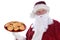 Santa Claus holding a large red platter full of fresh baked chocolate chip cookies, isolated on white