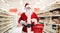 Santa claus holding a shopping basket in a supermarket