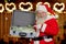 Santa Claus holding suitcase with money.