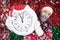 Santa Claus holds a clock in his hands against the background of the flag of Belarus