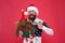 Santa Claus Ive been good. Santa point finger at reindeer toy. Happy bearded man with santa look. Secret santa gift