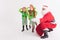 Santa Claus and Kids dressed in Elven costumes. North Pole.