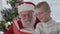Santa Claus and little boy read the book and laughing