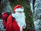 Santa Claus old adventurer with backpack in a cold winter forest. Individual Christmas celebration. Natural lifestyle