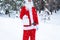 Santa Claus outdoor in winter and snow handing in hand paper bags with craft gift, food delivery. Shopping, packaging recycling,
