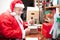 Santa Claus packing a gift