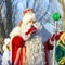 Santa Claus is photographed with children and their parents in the park