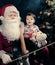 Santa Claus playing cello over dark background