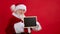 Santa Claus pointing in Mock Up blank advertisement banner isolated on red background with copy space. Santa Claus