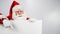 Santa Claus points to an empty white space. Promotional offer for Christmas.